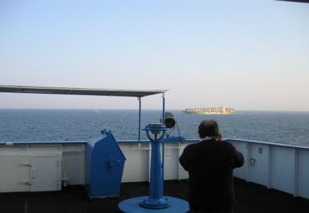 Pasajero de buque de carga observando el horizonte